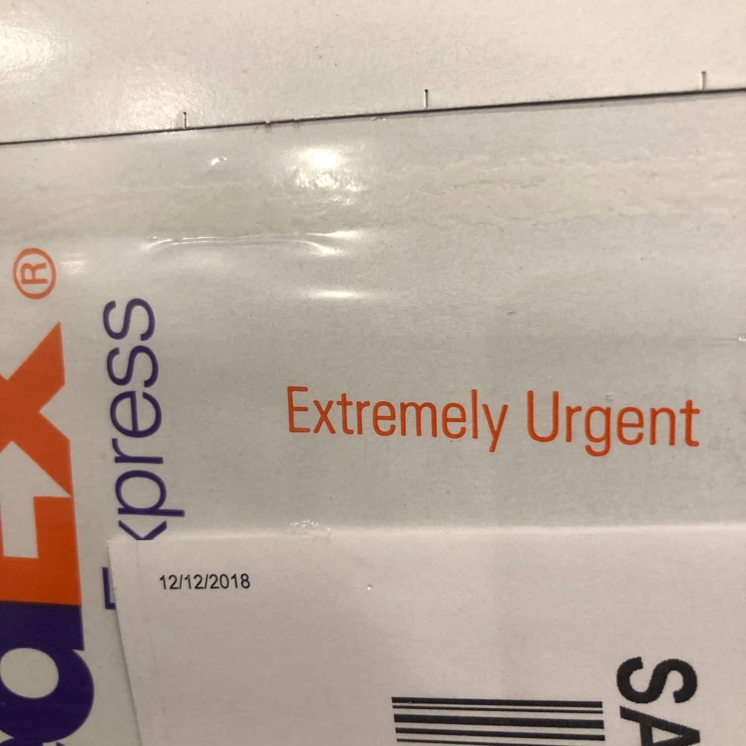 Photo of a courier envelope marked EXTREMELY URGENT