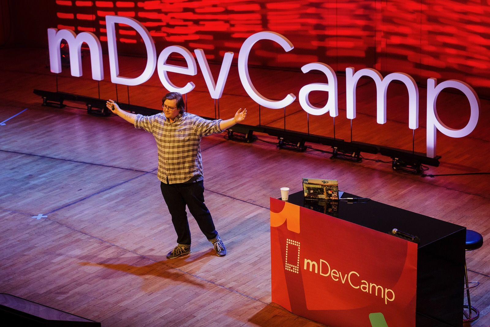 Photo of (a less younger) me speaking at mDevCamp.
