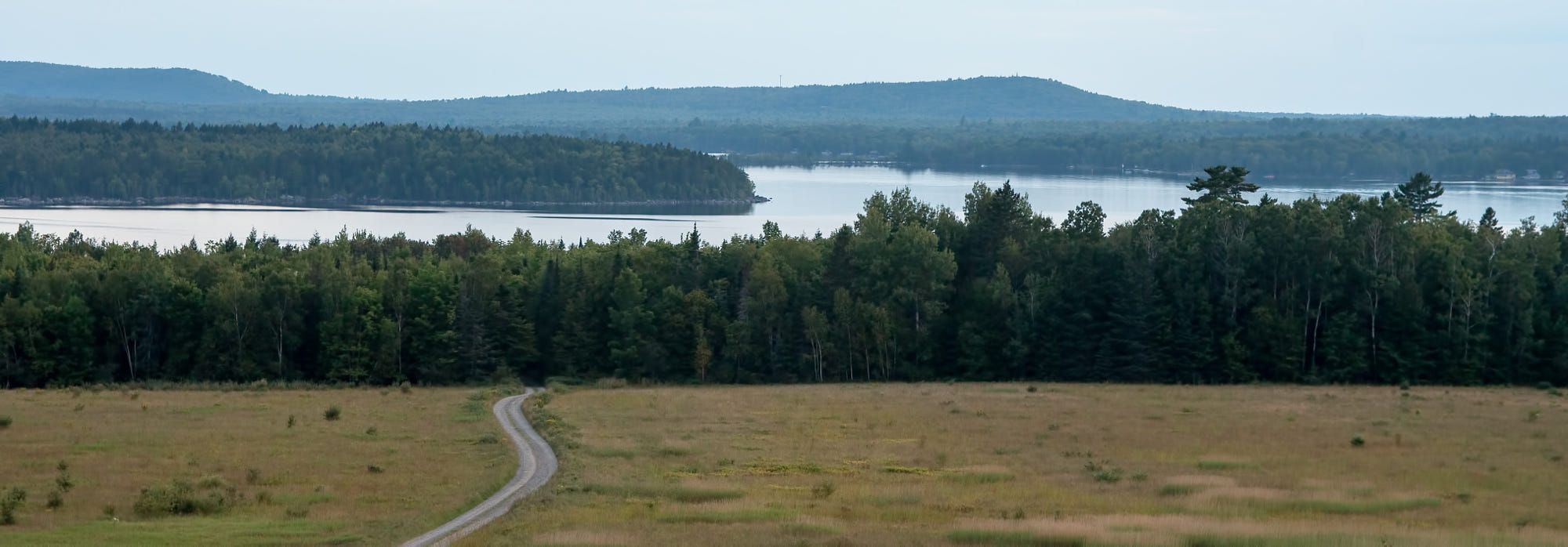 View of an open field looking over a lake