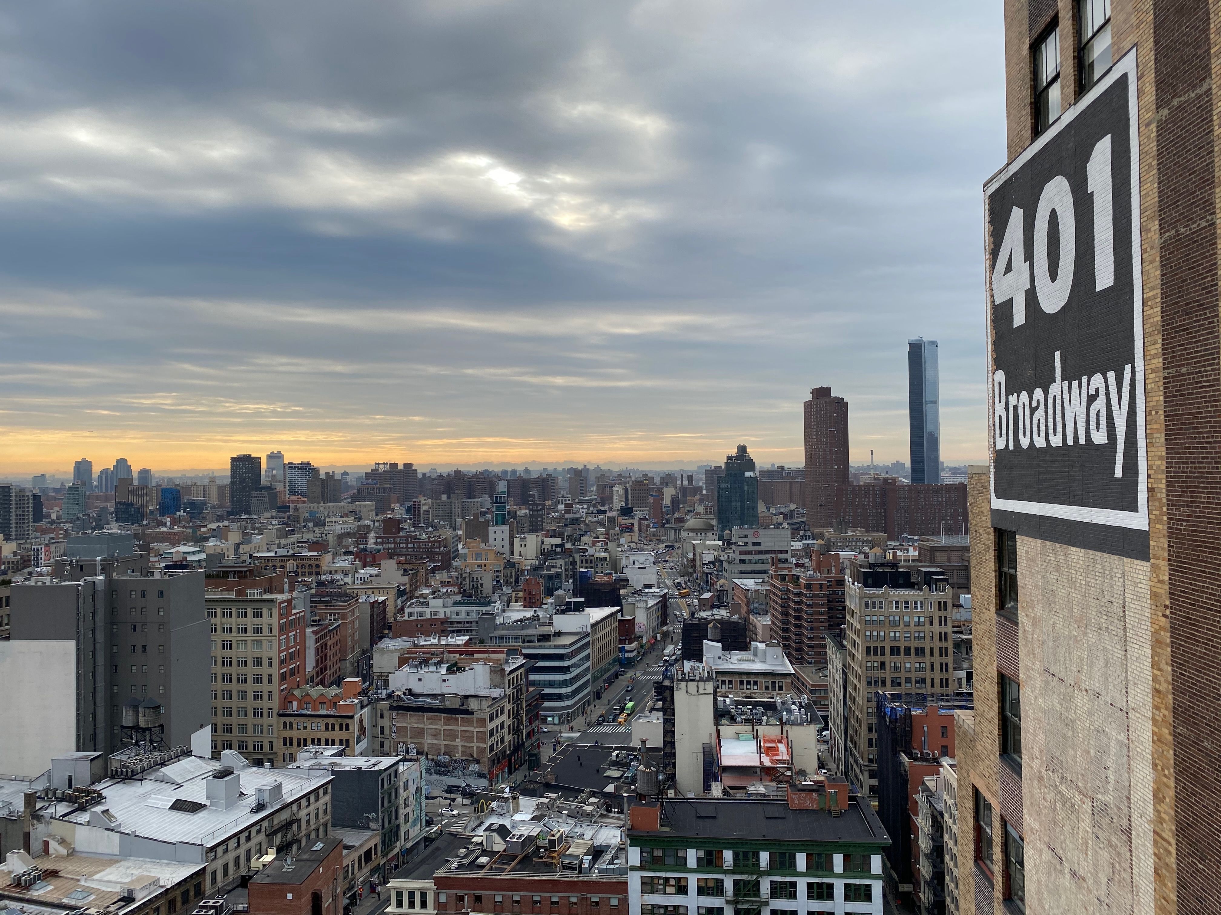 Photo of a building with the Manhattan skyline in the background.
