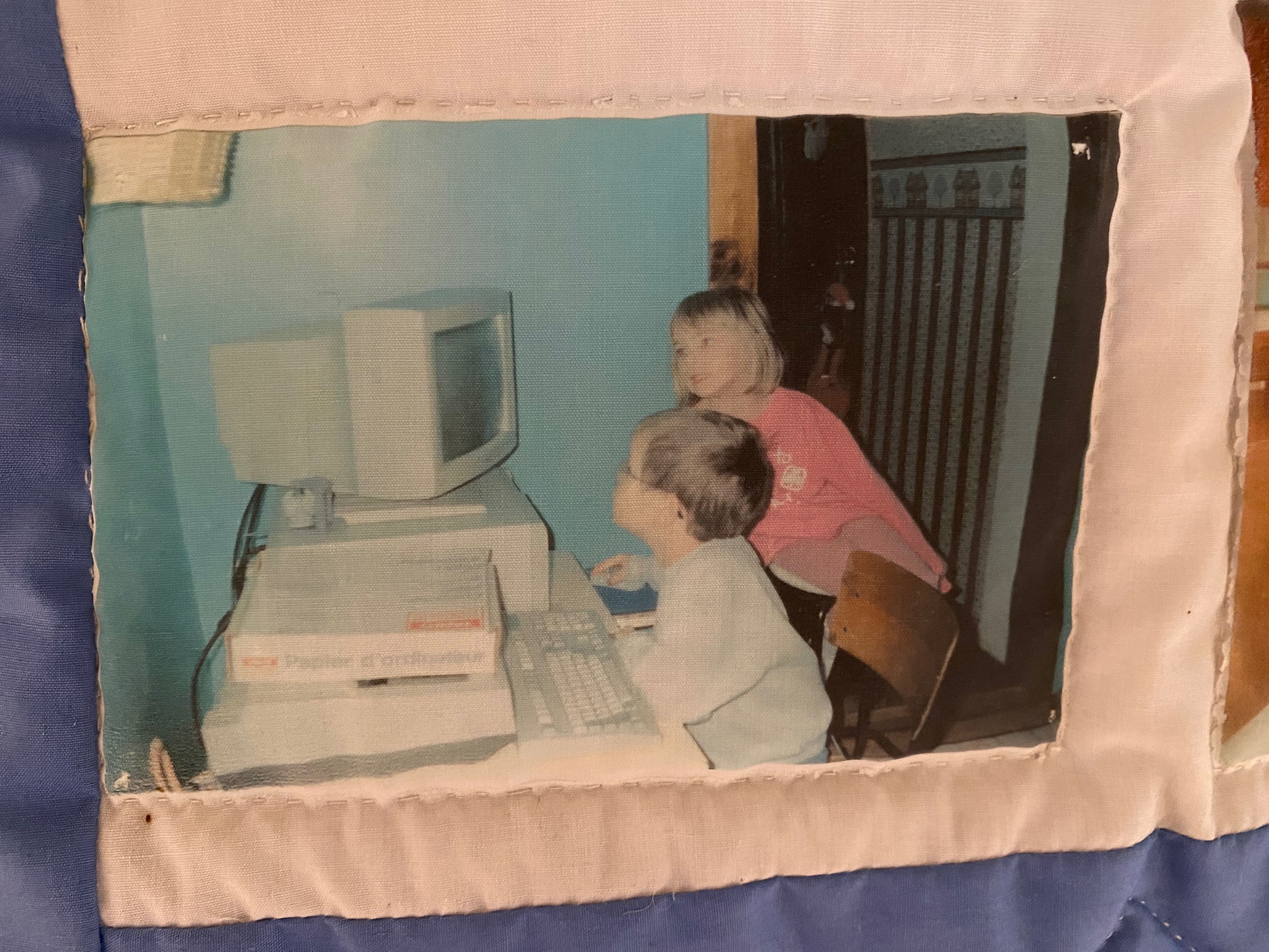 Photo of my sister and I looking at an old CRT computer monitor together.
