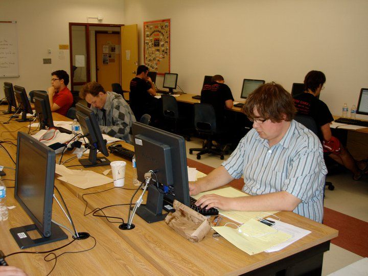 Photo of a computer lab where I am programming, with bad posture