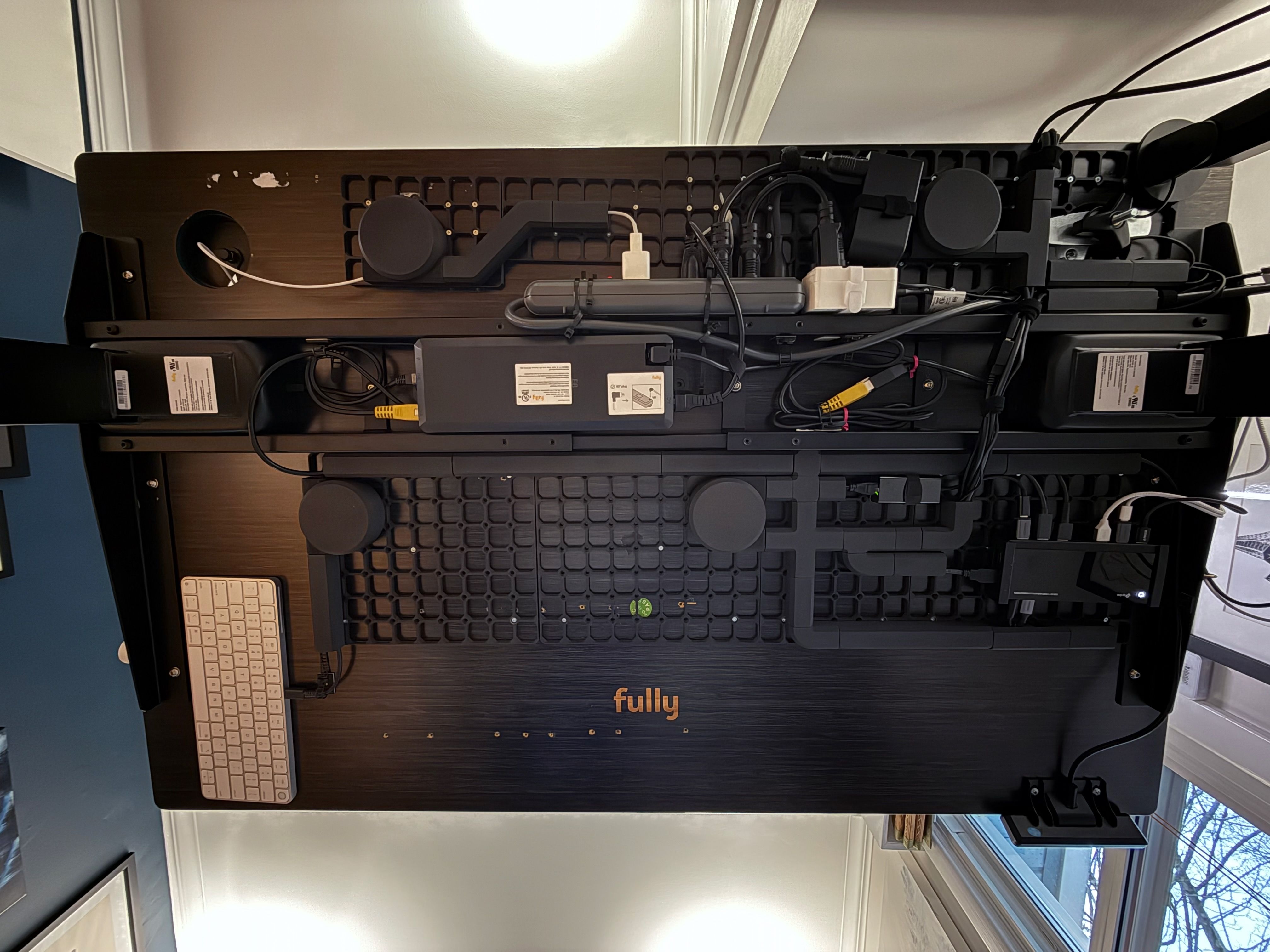 Photo of the underside of my desk, showing all the cable channels.