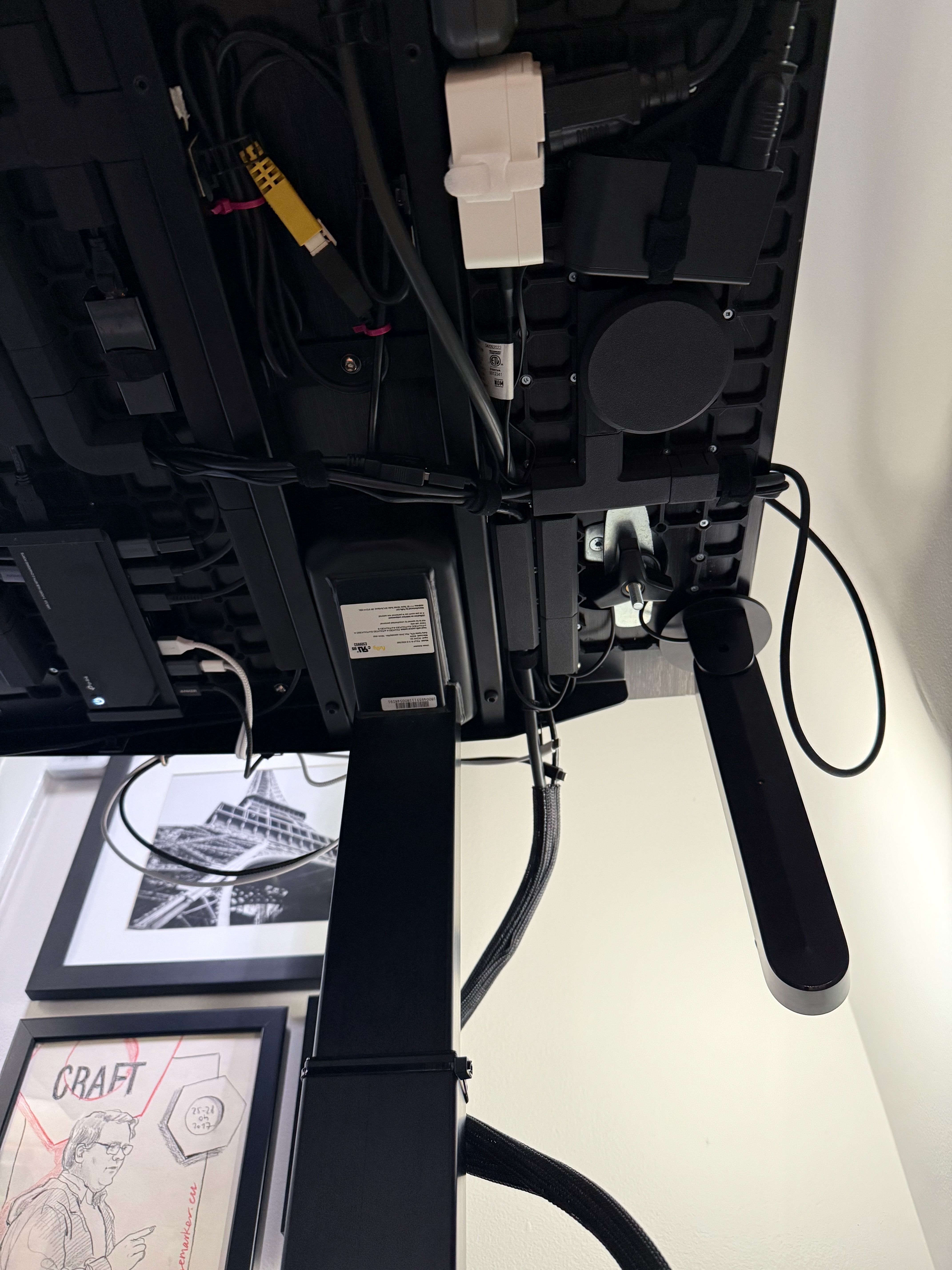 Photo of an upside down light bar projecting bias light against my wall, under my desk.